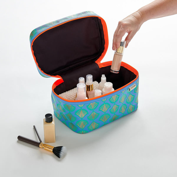 vanity case in shell blue print with hand removing bottle