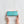 Female hands holding shell blue print make up bag