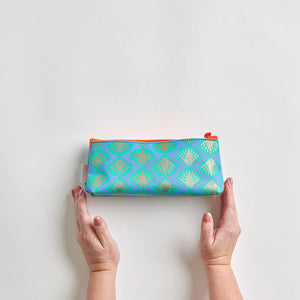 Female hands holding shell blue print make up bag