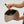 large makeup bag in gold with makeup brush