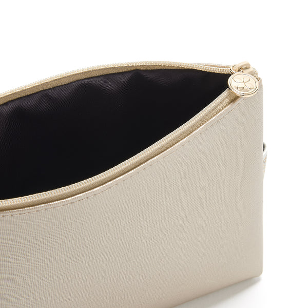 small makeup bag in gold with waterproof lining