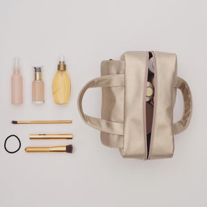Make-up being packed in gold large wash bag by Victoria Green 
