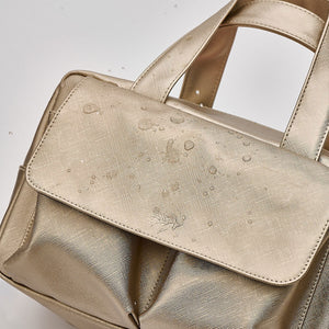 Large wash bag in gold made from waterproof material